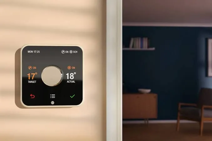 A Hive smart thermostat on a living-room wall